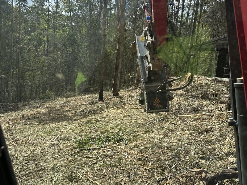 View from the operator&rsquo;s seat of an FAE flail mulcher head over freshly mulched ground